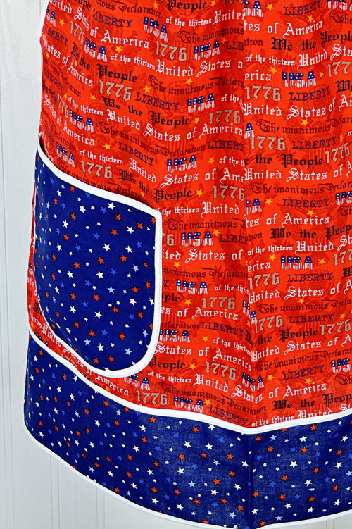 Close up of patriotic text on handmade apron for sale, red white blue 4th of July apron